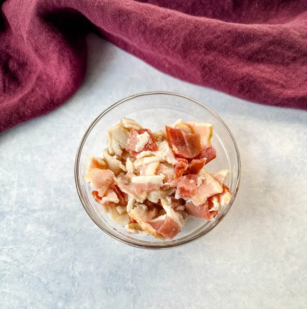 uncooked, diced bacon in a glass bowl