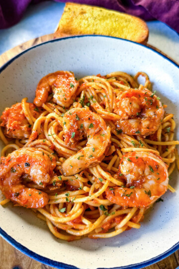 shrimp spaghetti with garlic in a white bowl