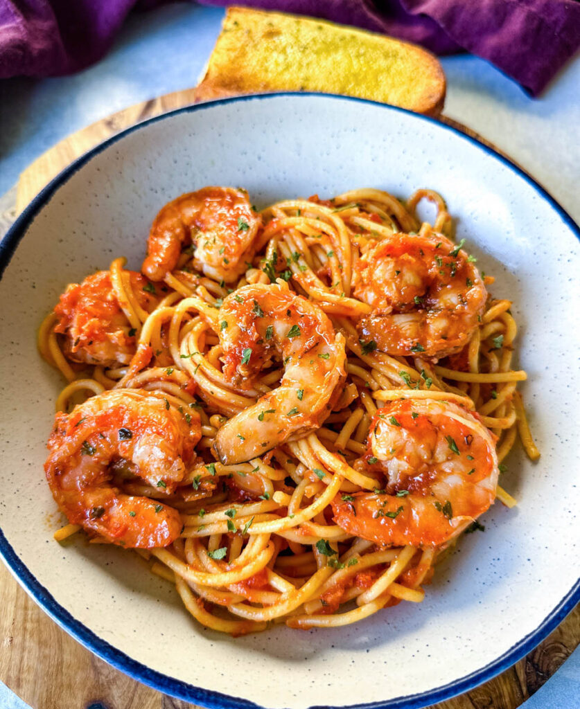 shrimp spaghetti with garlic in a white bowl