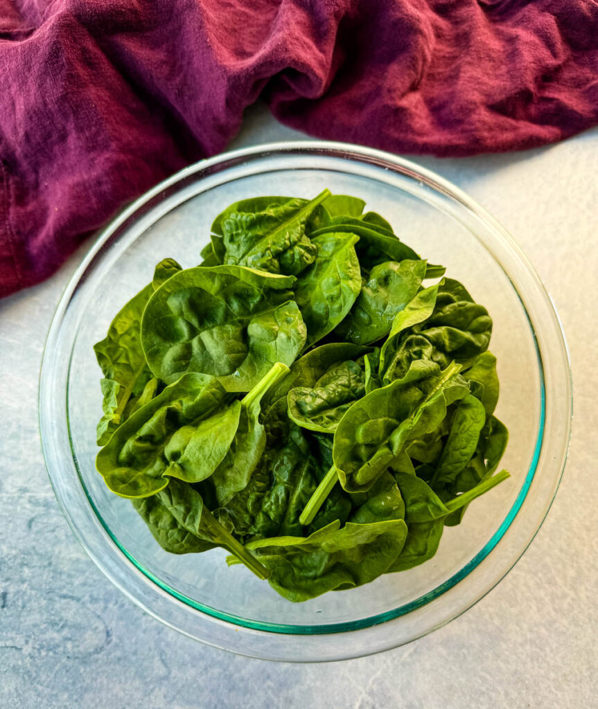 fresh spinach in a glass bowl