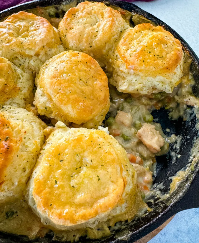 chicken pot pie with biscuits in a cast iron skillet