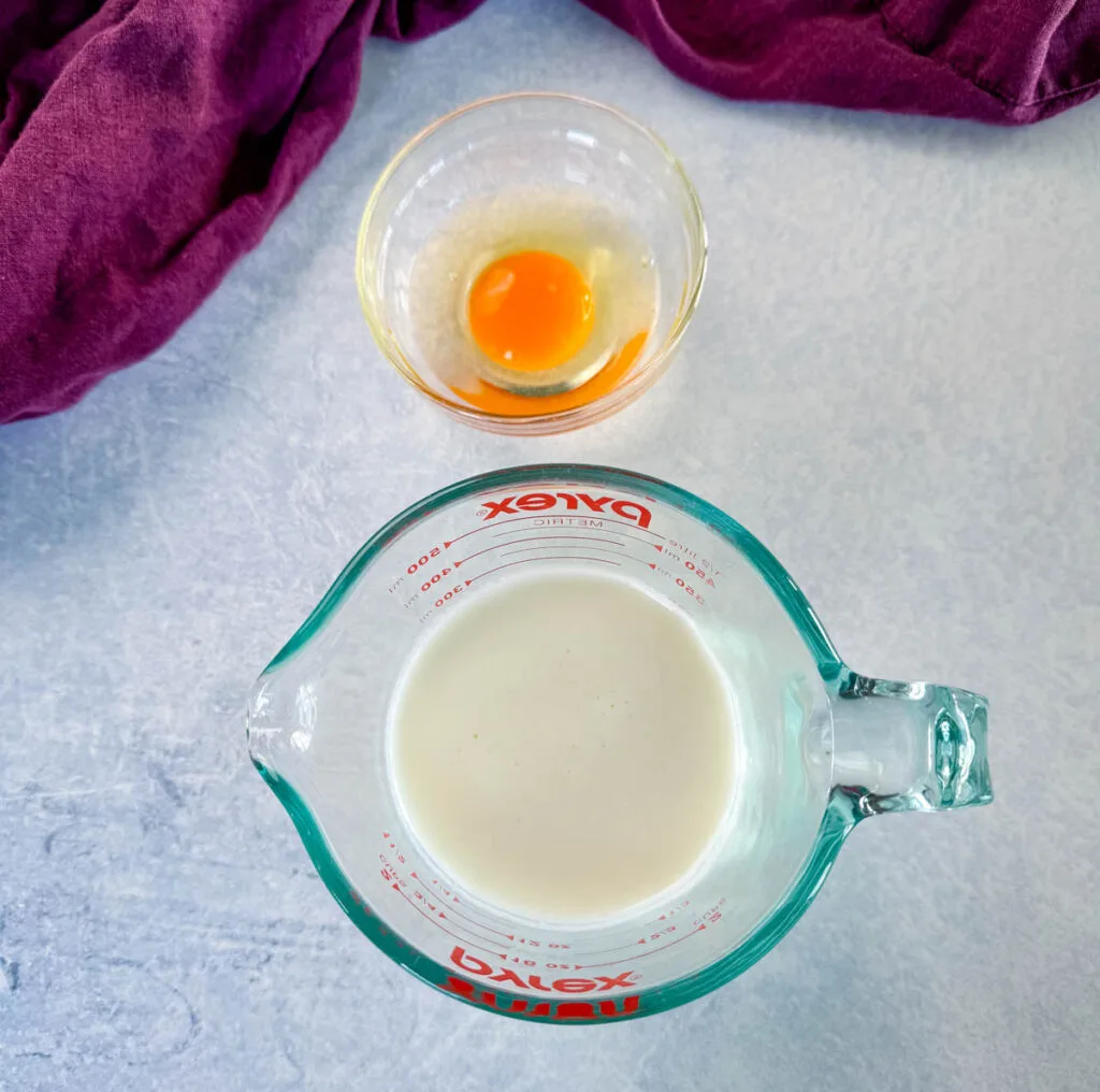 raw eggs and buttermilk in separate bowls