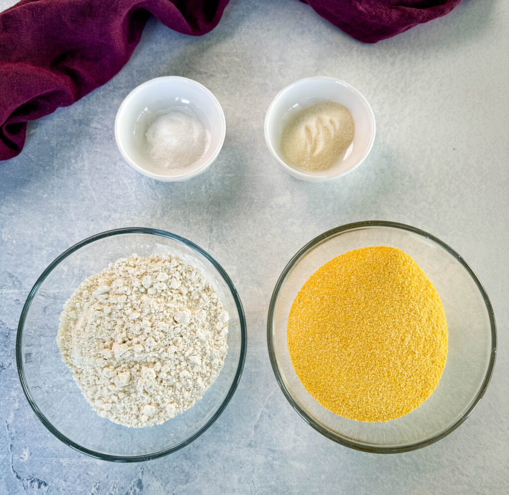 self rising flour, cornmeal, baking powder, sweetener, and salt in separate bowls