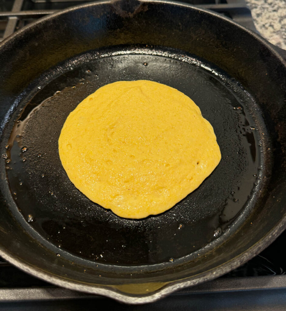 fried cornbread in a cast iron skillet