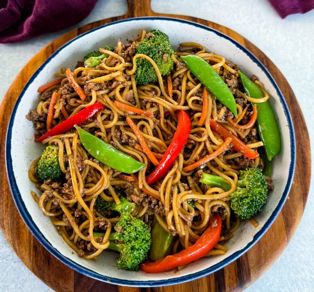 ground beef lo mein and vegetables in a white bowl