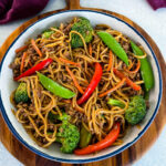 ground beef lo mein and vegetables in a white bowl