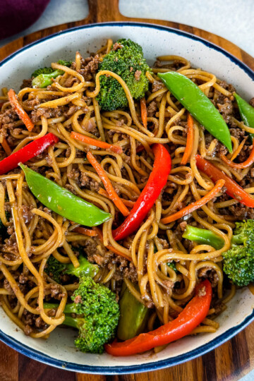 ground beef lo mein and vegetables in a white bowl