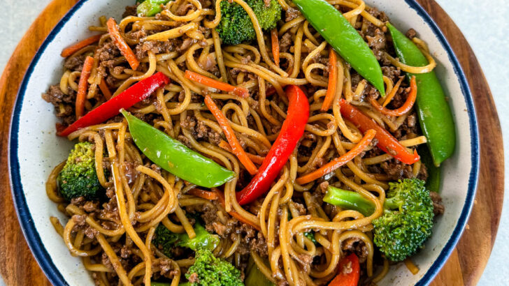 ground beef lo mein and vegetables in a white bowl