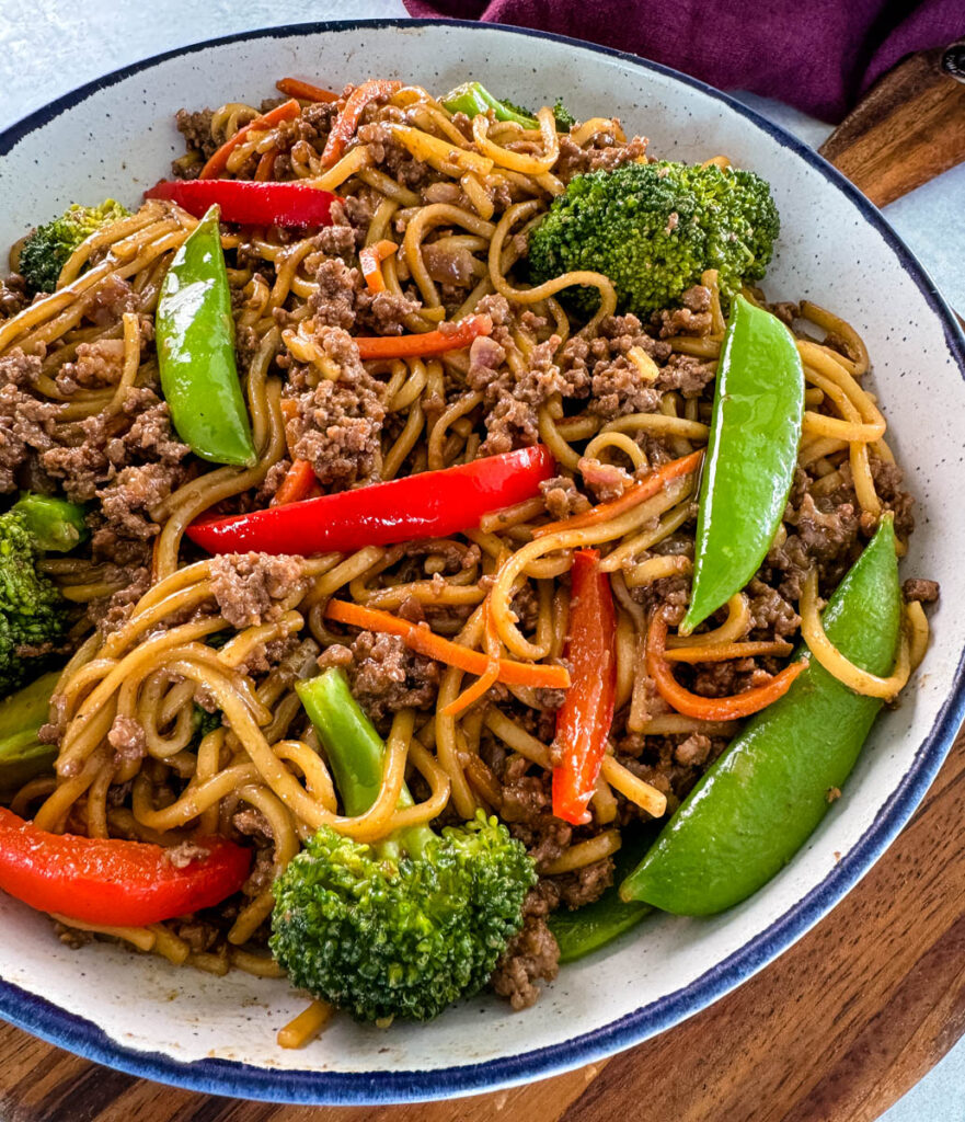 ground beef lo mein and vegetables in a white bowl