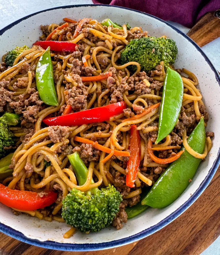 ground beef lo mein and vegetables in a white bowl