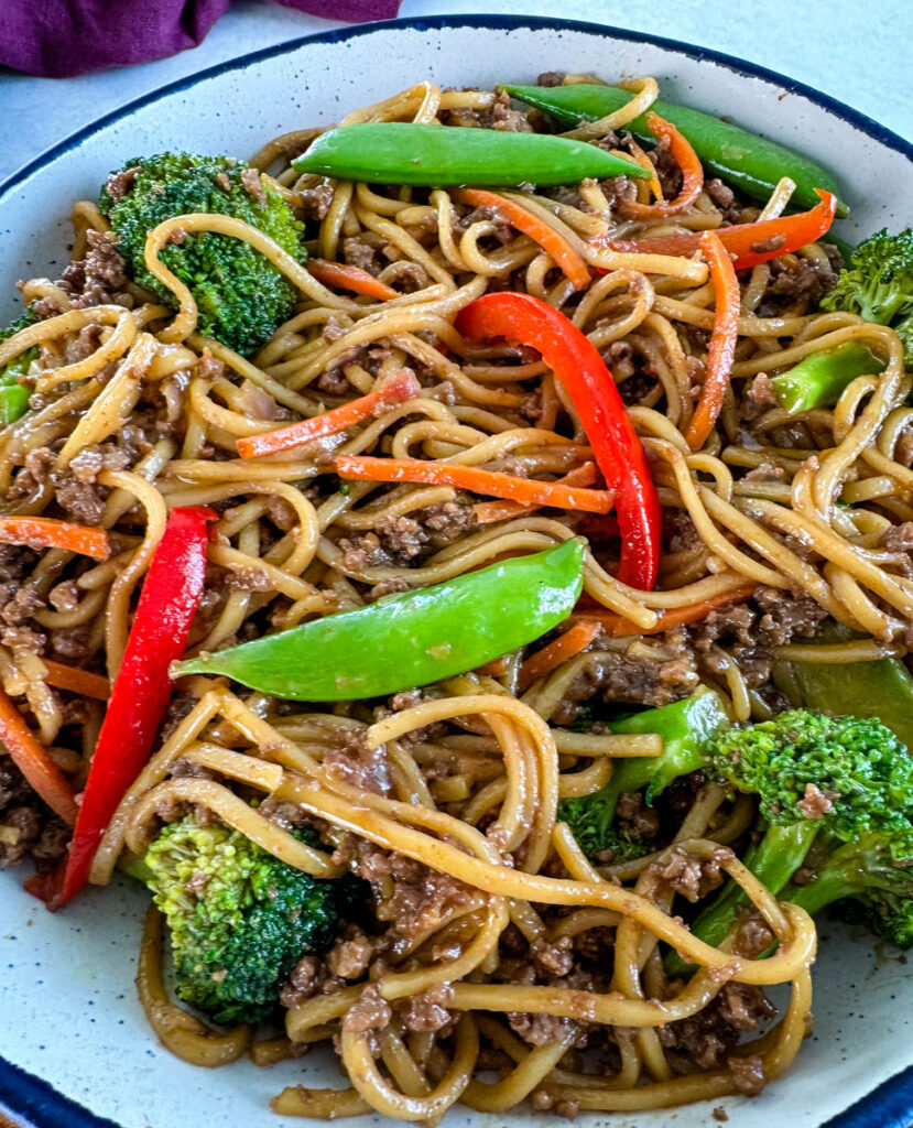 ground beef lo mein and vegetables in a white bowl