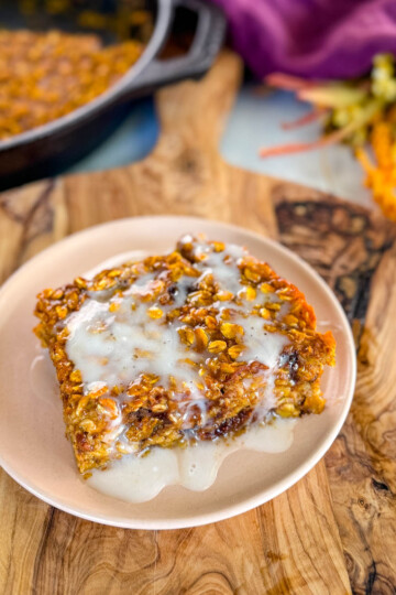 pumpkin baked oatmeal with on a plate drizzled with icing