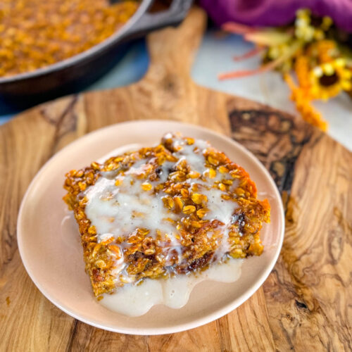 pumpkin baked oatmeal with on a plate drizzled with icing