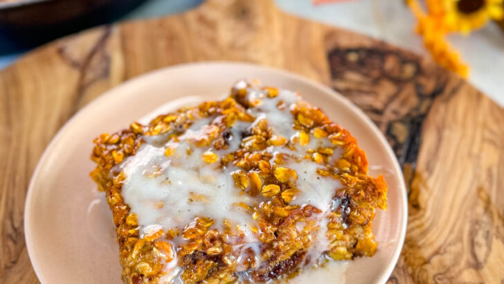 pumpkin baked oatmeal with on a plate drizzled with icing