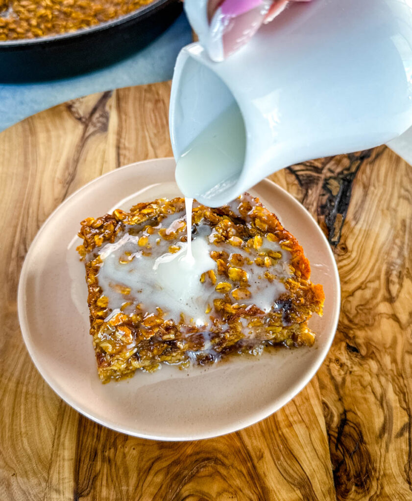 pumpkin baked oatmeal with on a plate drizzled with icing