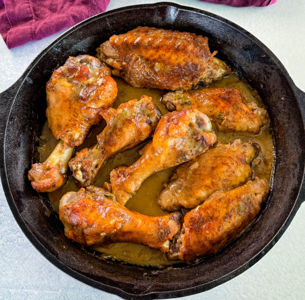 cooked turkey wings and gravy in a cast iron skillet