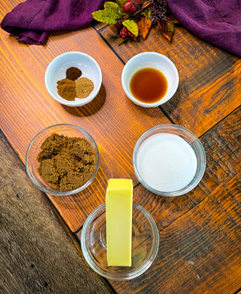 cinnamon, nutmeg, clove, vanilla extract, brown sugar, white sugar, and butter in separate glass bowls