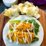 chicken snack wrap on a tortilla with ranch dressing and shredded cheese with chips