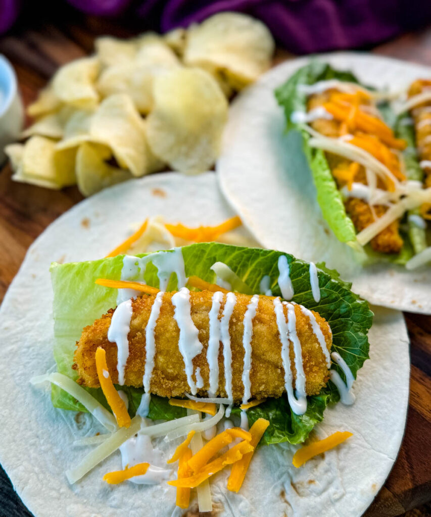 chicken snack wrap on a tortilla with ranch dressing and shredded cheese