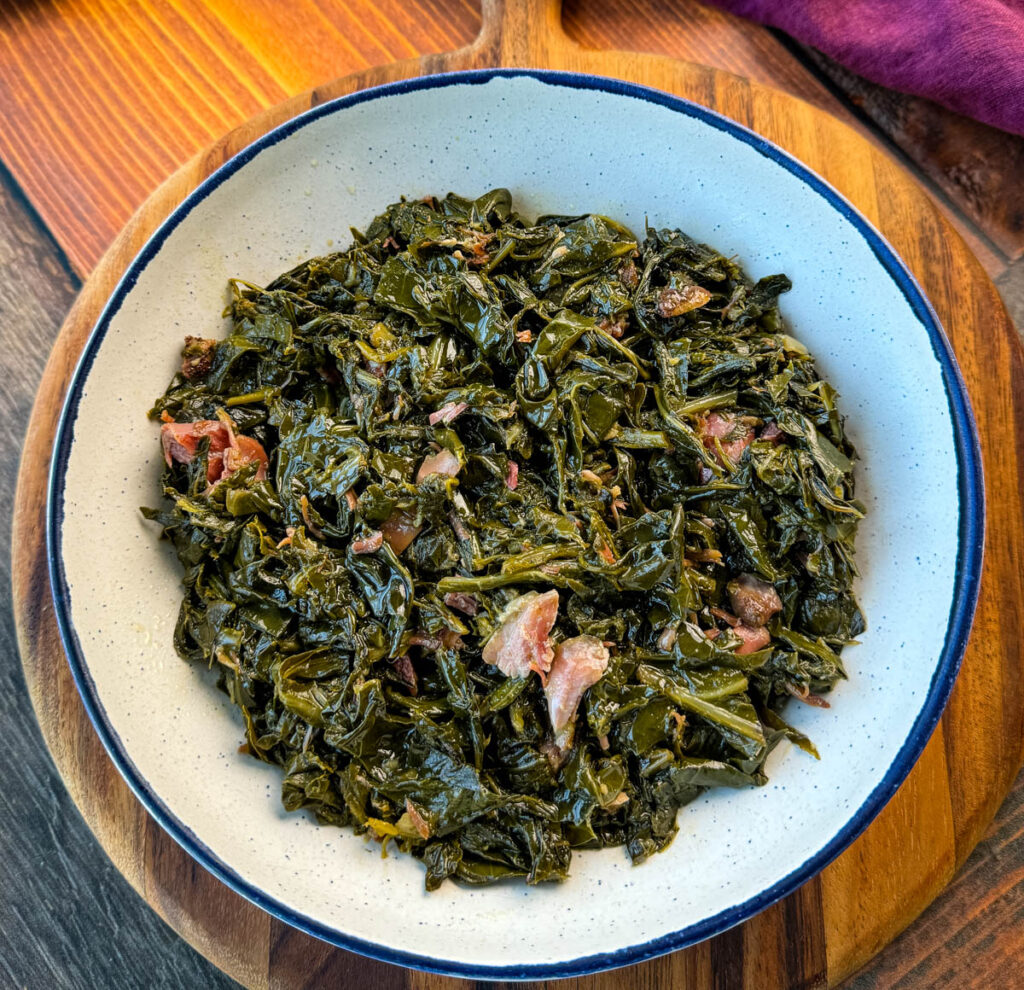 collard greens and ham hocks in a white bowl