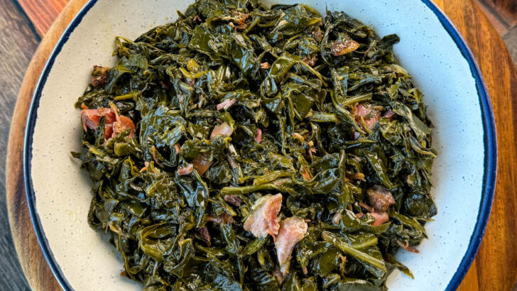 collard greens and ham hocks in a white bowl