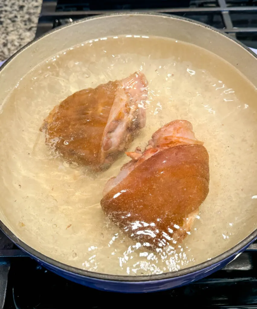 smoked ham hocks in a pot with water