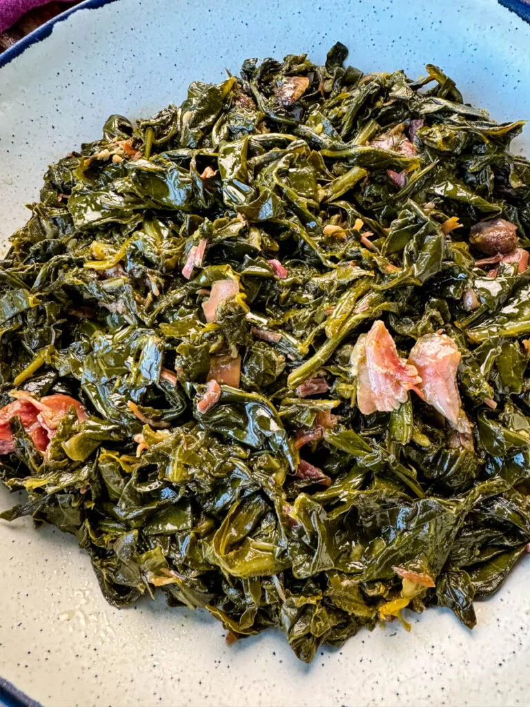 collard greens and ham hocks in a Dutch oven