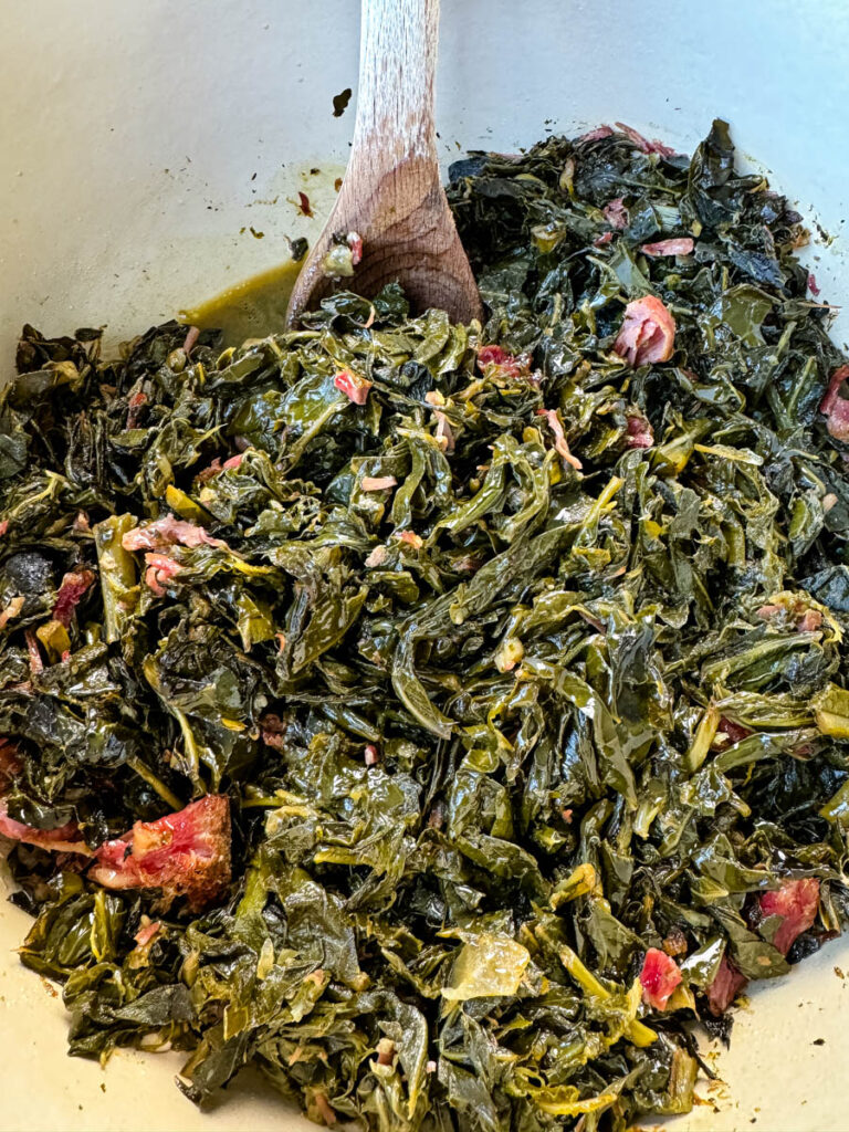 collard greens and ham hocks in a Dutch oven