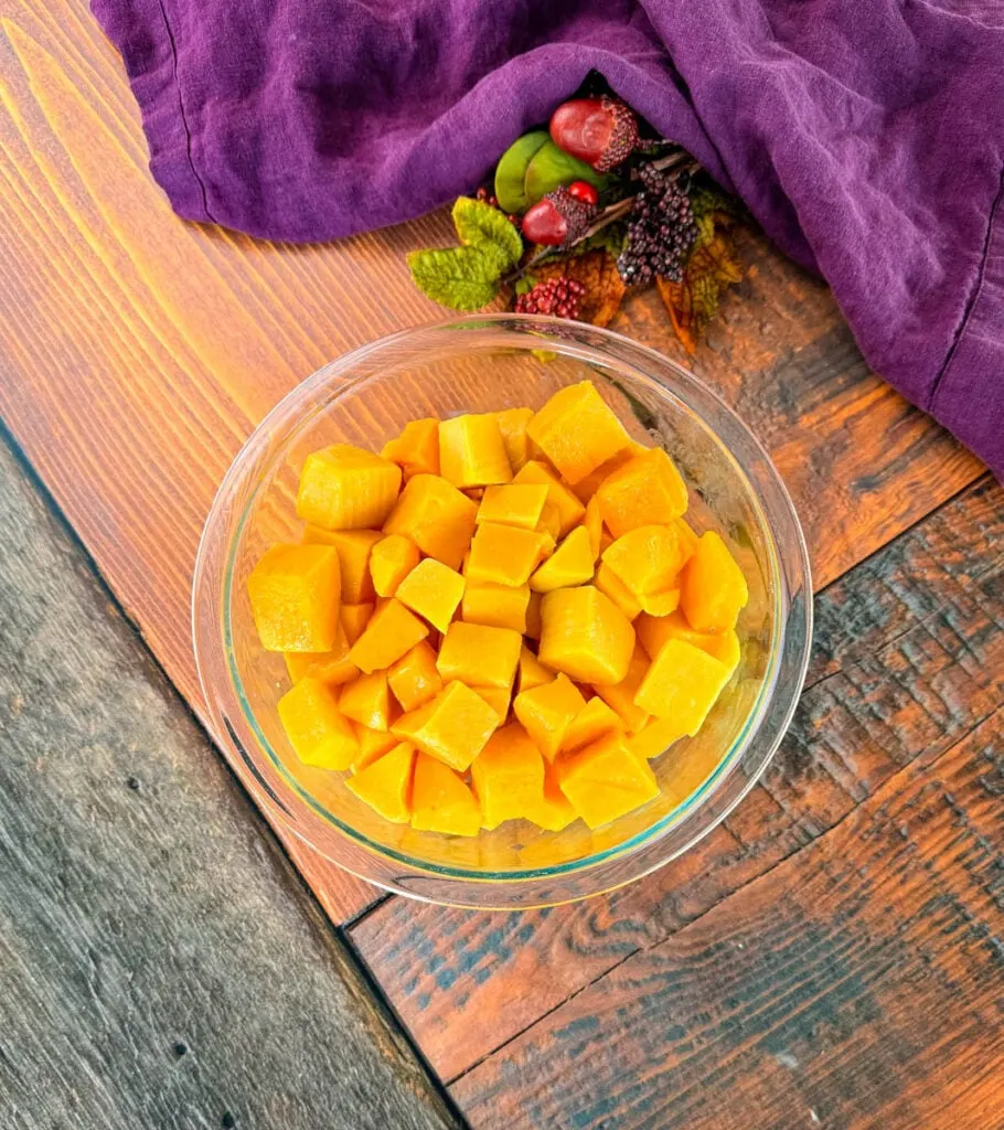 diced chunks of butternut squash in a glass bowl