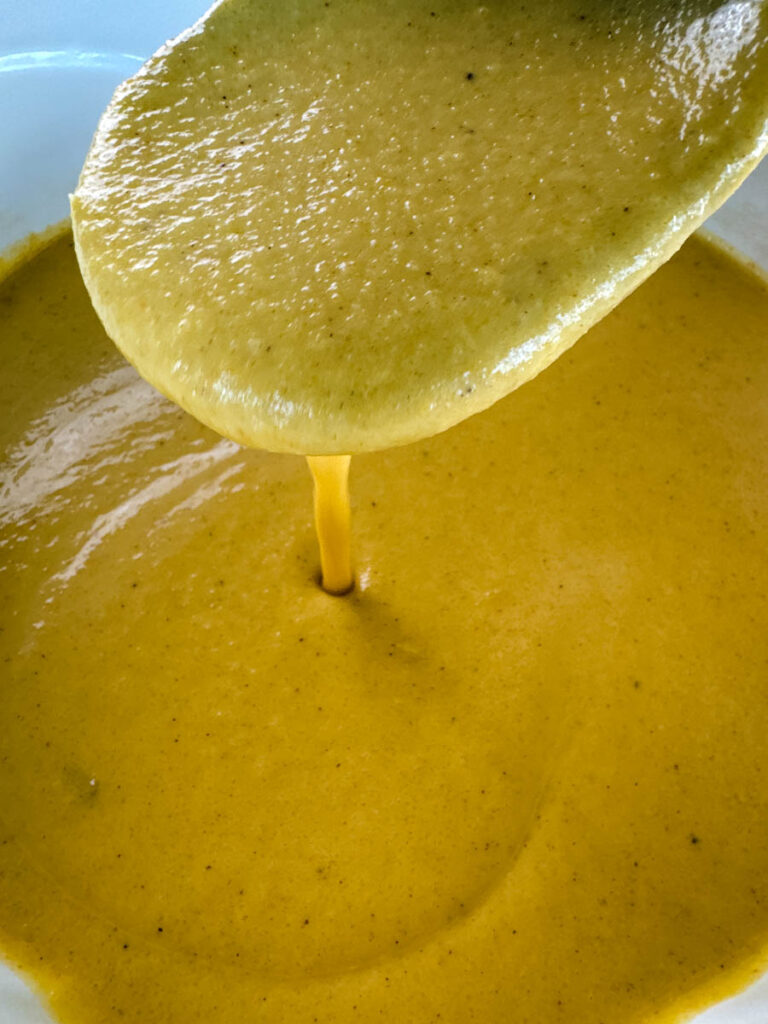 a wooden spoonful of creamy butternut squash soup