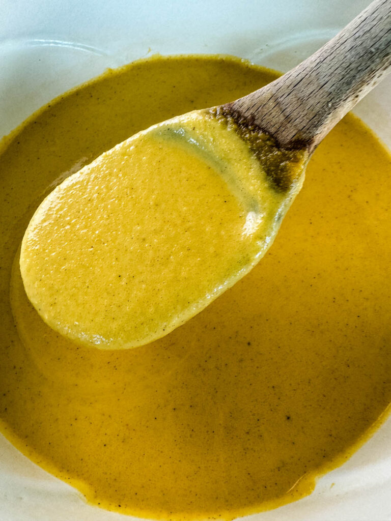 a wooden spoonful of creamy butternut squash soup