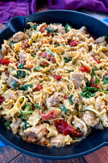 pot full of marry me chicken pasta with sundried tomatoes, parmesan, and spinach