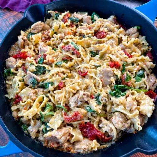 pot full of marry me chicken pasta with sundried tomatoes, parmesan, and spinach