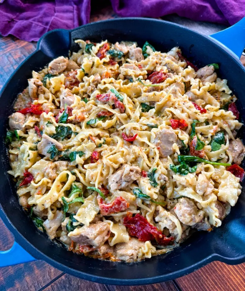 pot full of marry me chicken pasta with sundried tomatoes, parmesan, and spinach