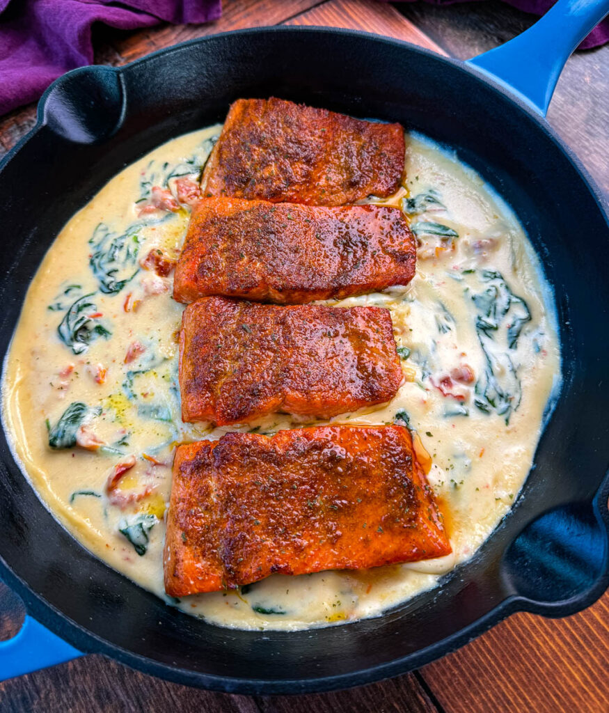 Tuscan style marry me salmon with cream sauce in a skillet