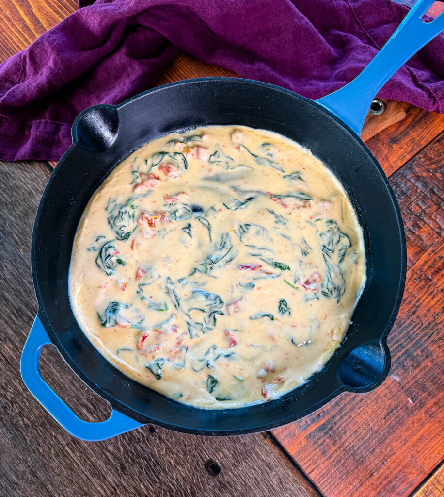 Tuscan marry me cream sauce in a blue skillet