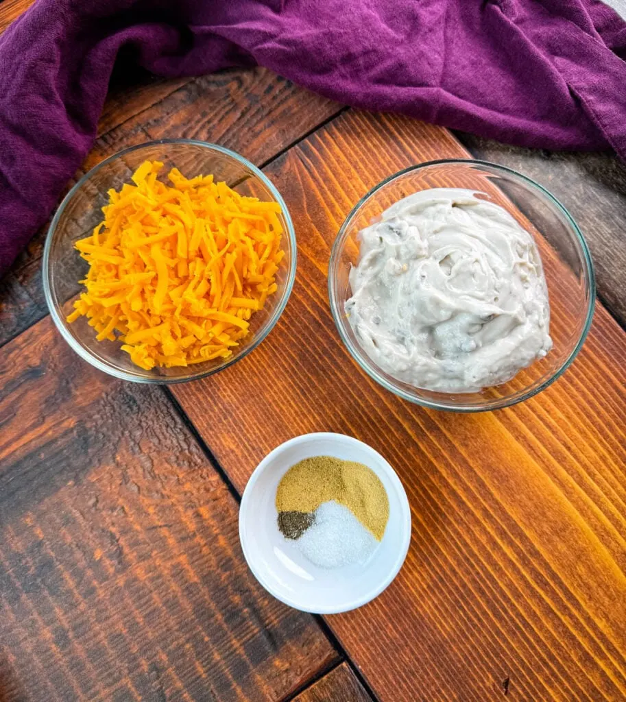 grated cheddar cheese, homemade cream of soup, and spices in separate bowls