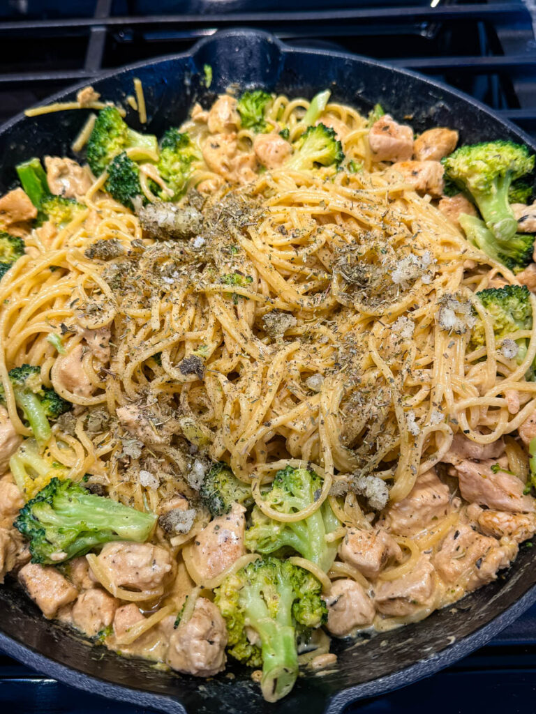 creamy chicken broccoli with Italian seasoning Alfredo sauce in a skillet