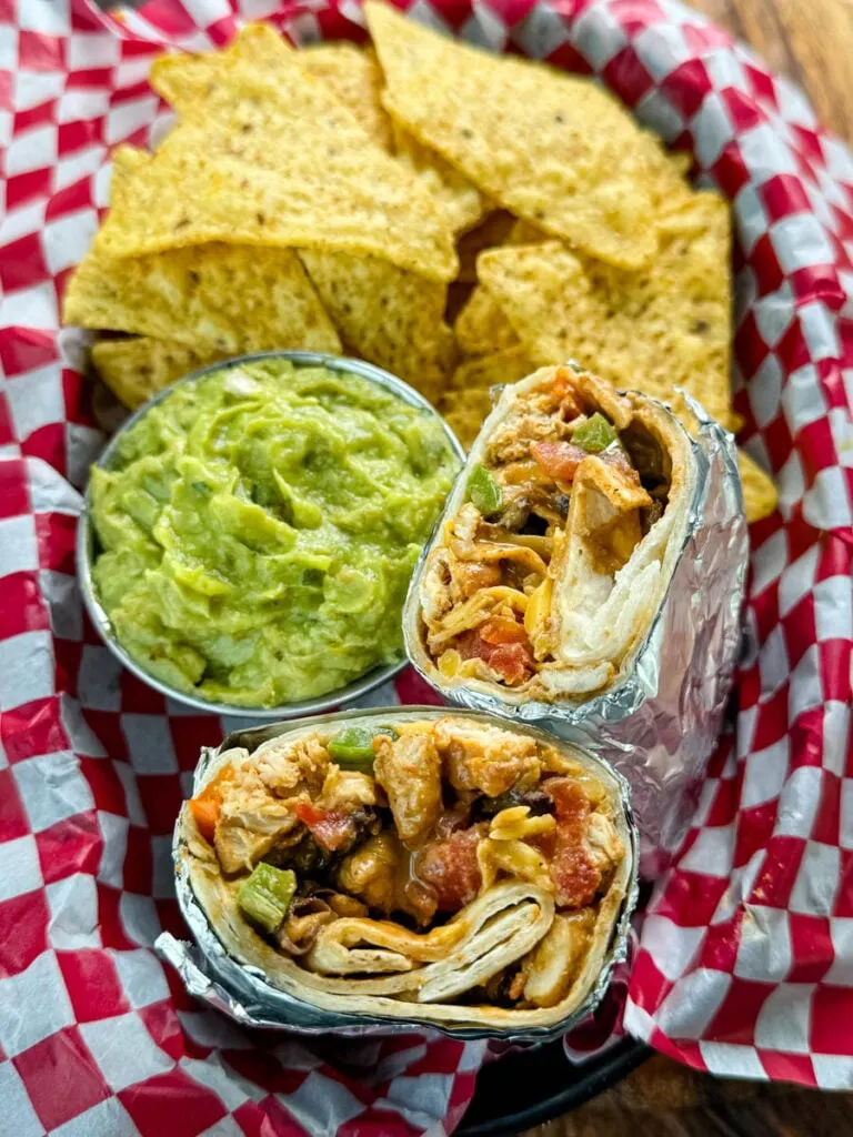 high protein chicken burritos, guacamole, and chips in a bowl