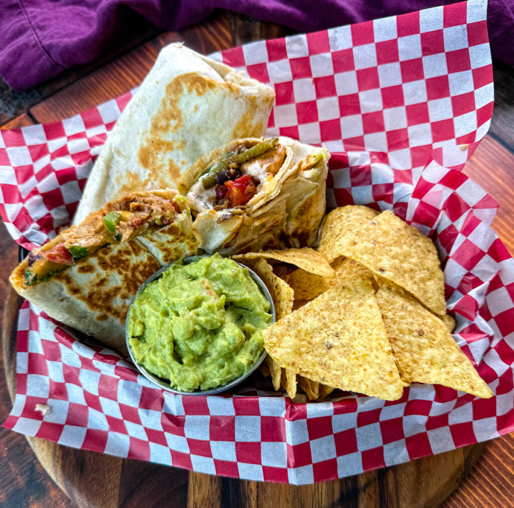 high protein chicken burritos, guacamole, and chips in a bowl