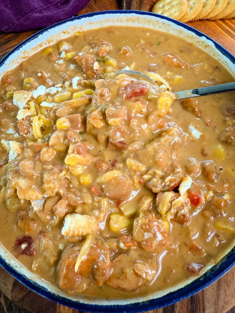 high protein chicken chili in a white bowl with a spoon