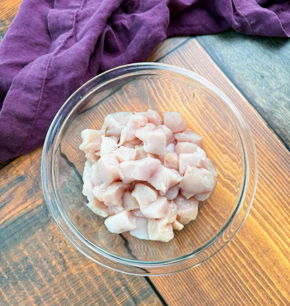 raw sliced chicken breast in a glass bowl