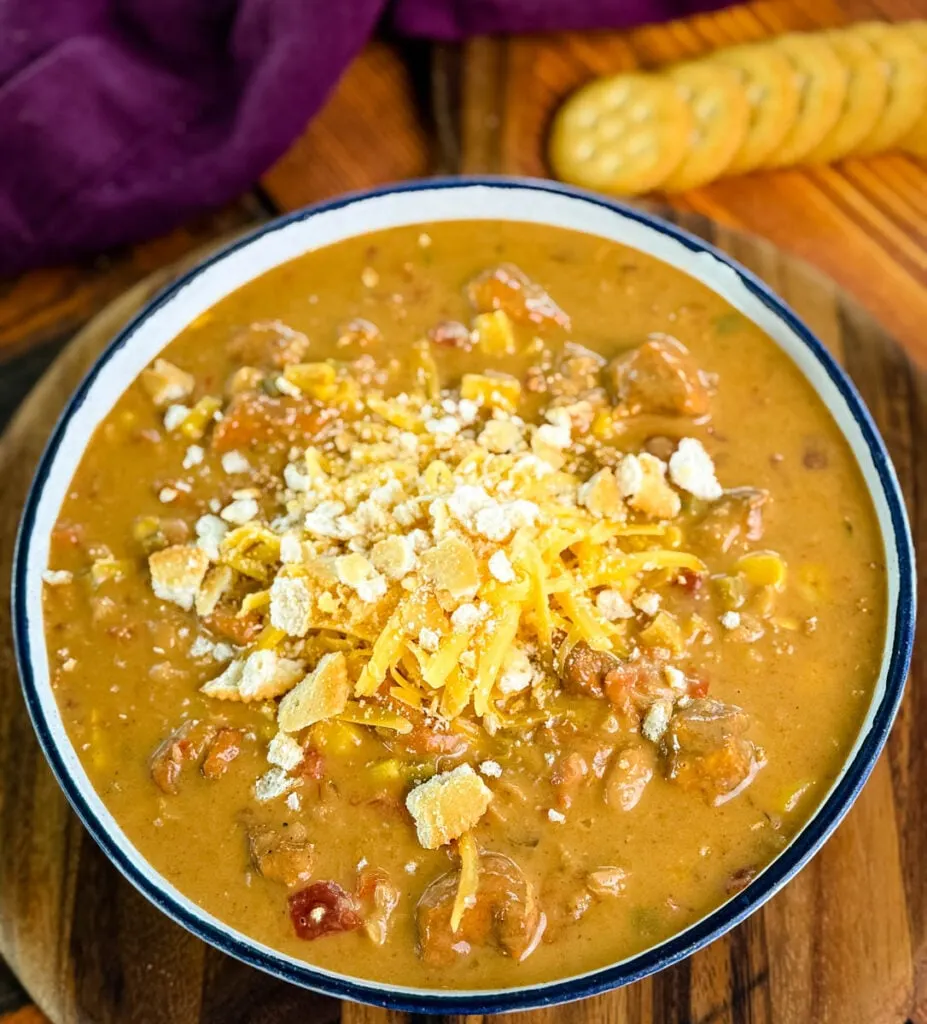 high protein chicken chili in a white bowl with crackers and a spoon