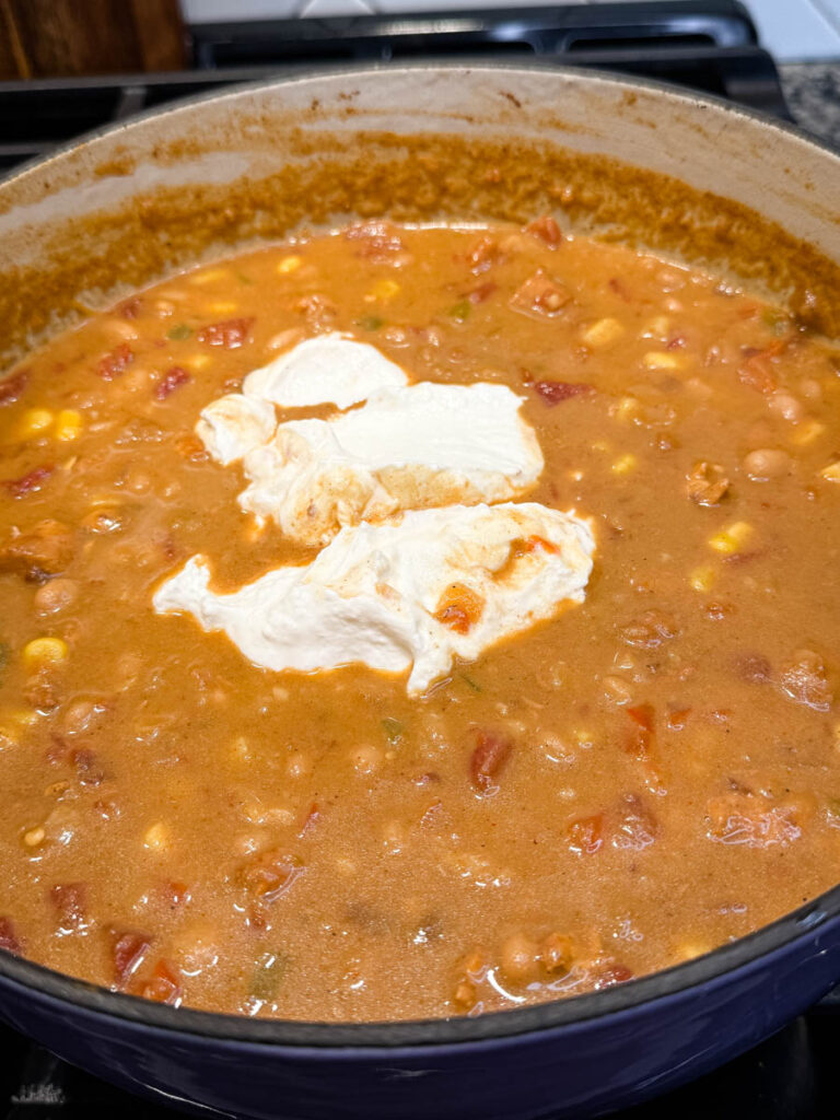 high protein chicken chili in a pot with plain Greek yogurt