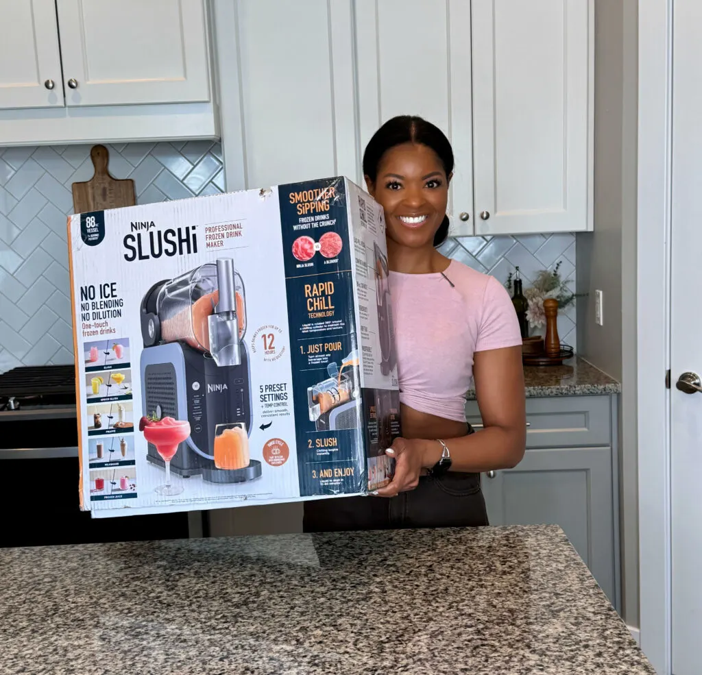 person holding Ninja slushi box in a kitchen