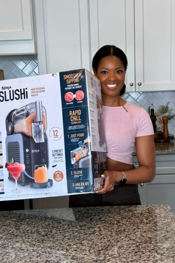 person holding Ninja slushi box in a kitchen