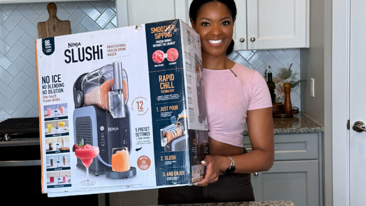 person holding Ninja slushi box in a kitchen